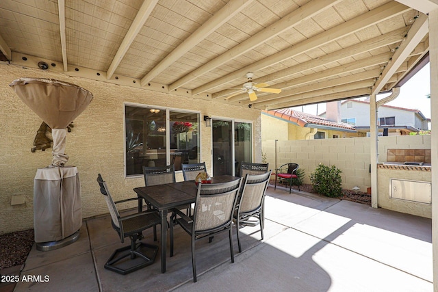 view of patio with outdoor dining space, a ceiling fan, and fence