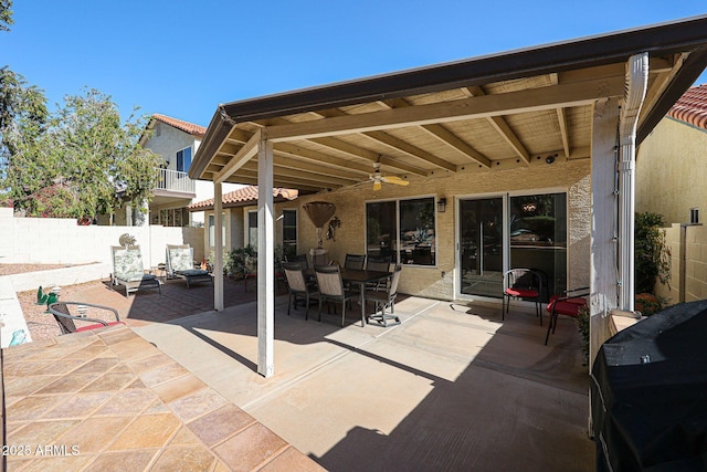 view of patio / terrace featuring grilling area, outdoor dining area, ceiling fan, and fence