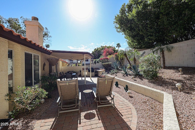 view of patio with outdoor dining space and a fenced backyard