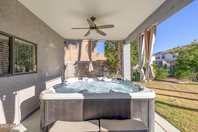 view of patio / terrace featuring ceiling fan and a hot tub