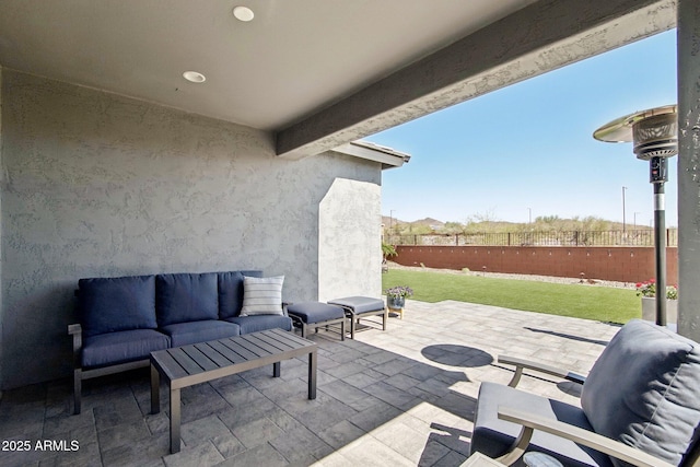 view of patio / terrace with an outdoor living space and fence