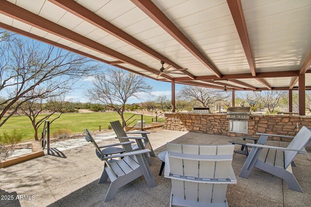 view of patio featuring ceiling fan, an outdoor fire pit, area for grilling, and grilling area