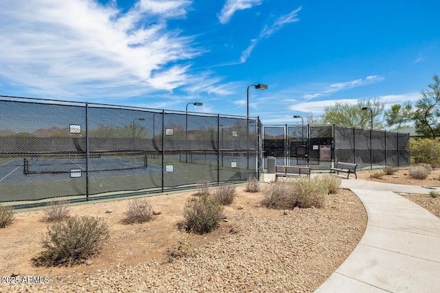 view of tennis court featuring fence