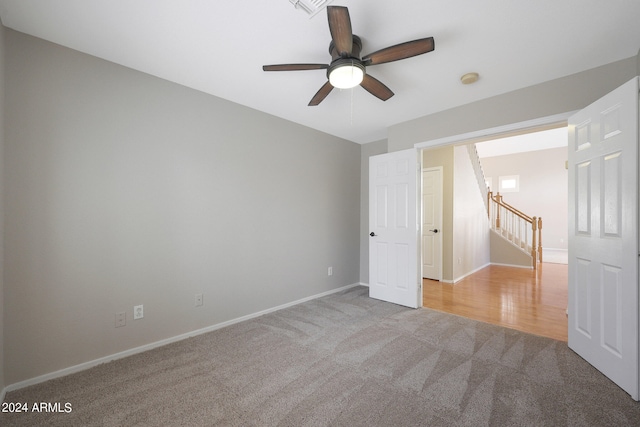 unfurnished bedroom featuring ceiling fan and light colored carpet