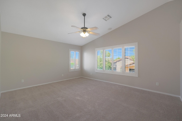 spare room with lofted ceiling, ceiling fan, and carpet flooring