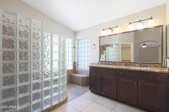 bathroom featuring vanity, lofted ceiling, ceiling fan, plus walk in shower, and tile patterned floors