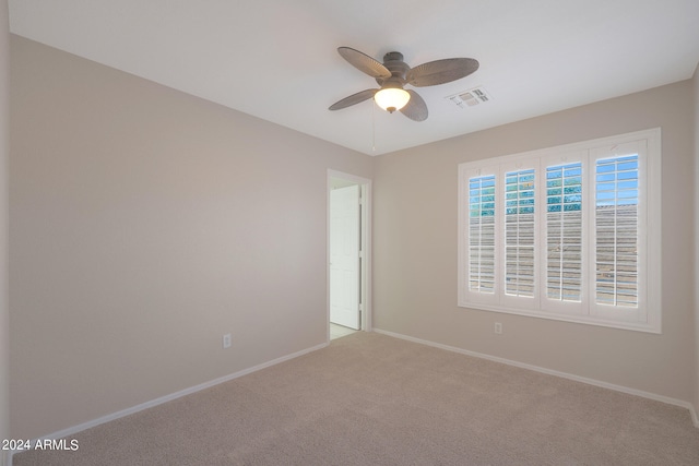 empty room with ceiling fan and carpet floors