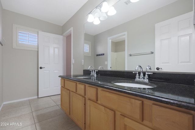 bathroom featuring vanity, tile patterned flooring, and a wealth of natural light