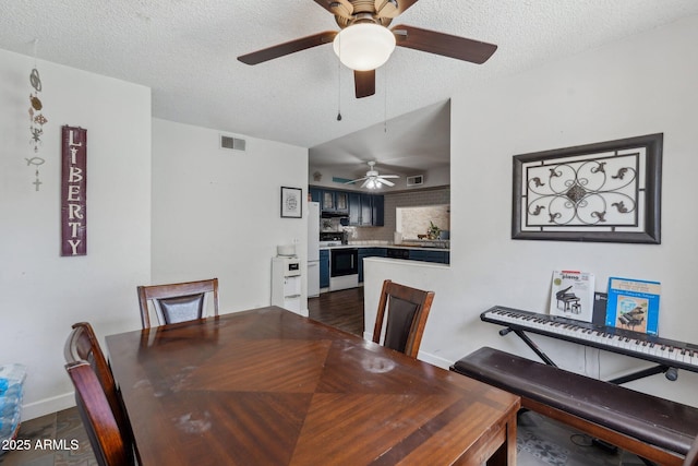 dining room with visible vents, a ceiling fan, and a textured ceiling