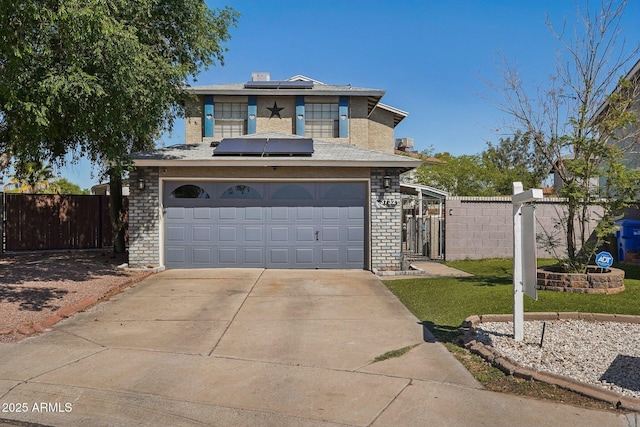 traditional-style home featuring a garage, fence, solar panels, a gate, and driveway