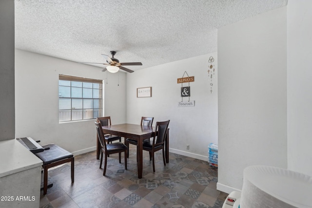 dining room with a textured ceiling, ceiling fan, and baseboards