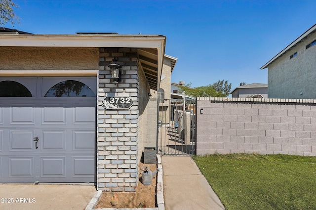view of home's exterior with a garage, fence, stone siding, and a gate
