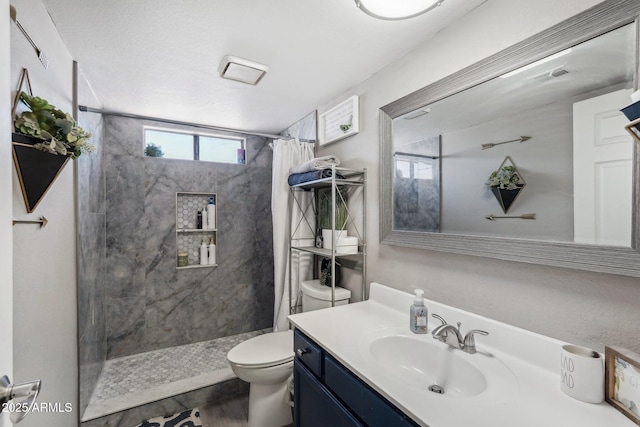 bathroom featuring vanity, a shower with curtain, toilet, and wood finished floors