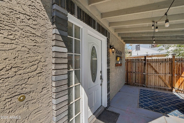 property entrance featuring fence and a gate