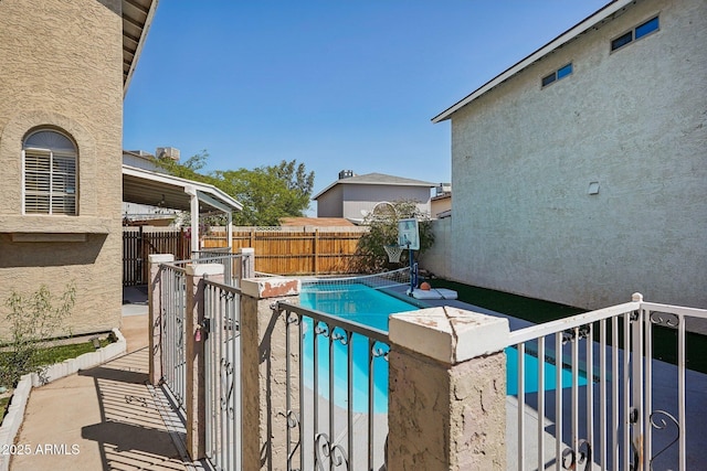 view of swimming pool featuring a patio area, a fenced in pool, and fence private yard
