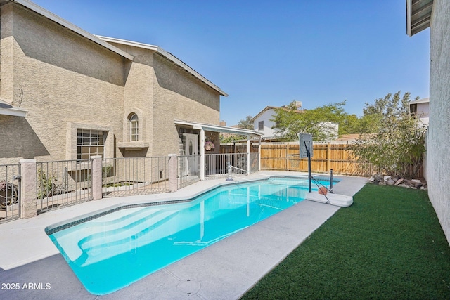 view of swimming pool with a patio, a yard, a fenced backyard, and a fenced in pool