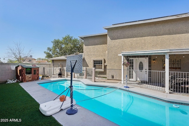 view of pool featuring a fenced in pool, a patio, a fenced backyard, and a lawn