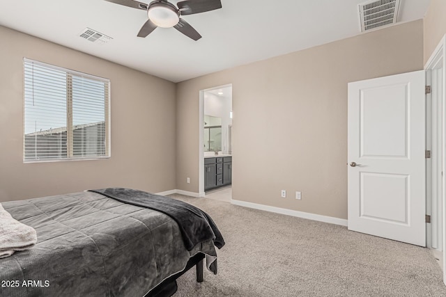16877 W Butler Ave, Waddell, AZ 85355 - bedroom with light carpet, baseboards, ensuite bathroom, and ceiling fan