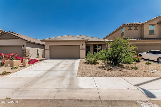 16877 W Butler Ave, Waddell, AZ 85355 - view of front of property with stucco siding, a tile roof, concrete driveway, and a garage