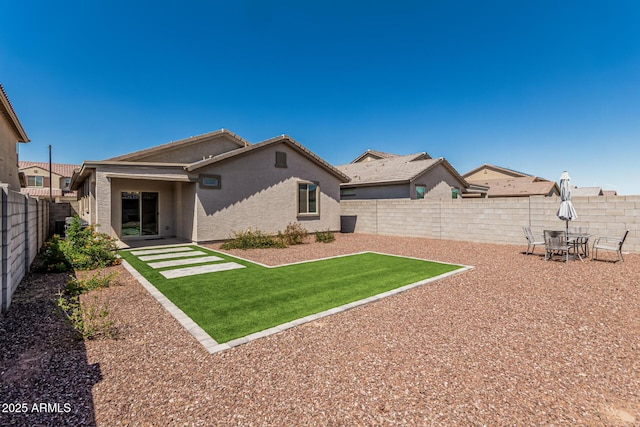 16877 W Butler Ave, Waddell, AZ 85355 - rear view of property featuring stucco siding and a patio