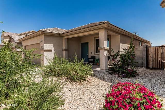 16877 W Butler Ave, Waddell, AZ 85355 - view of front of home with stucco siding, an attached garage, fence, and a tiled roof