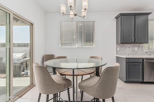16877 W Butler Ave, Waddell, AZ 85355 - dining room with a chandelier and light tile patterned floors