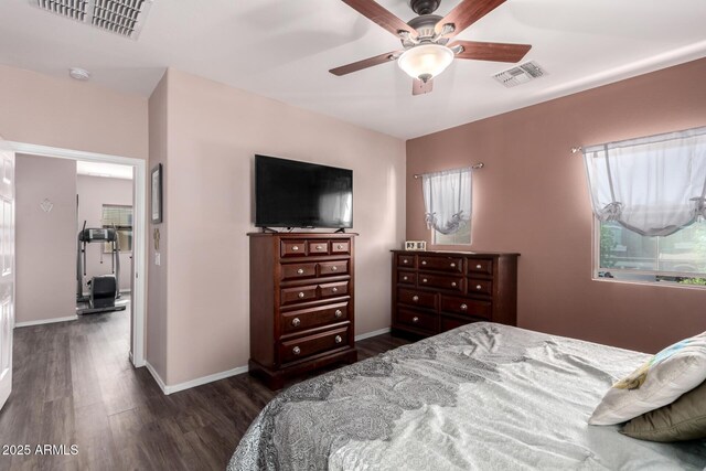 bedroom featuring visible vents, baseboards, and dark wood-style floors