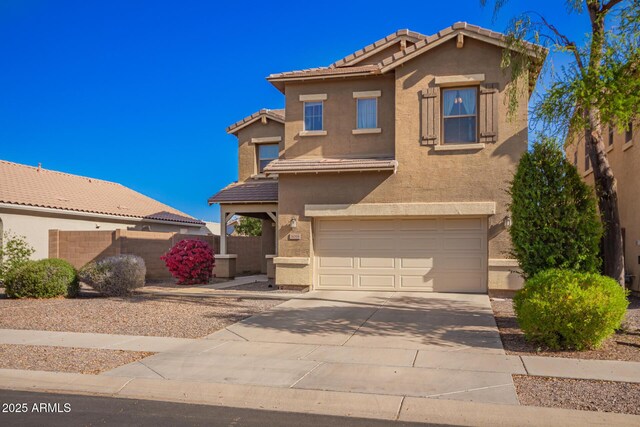 view of front facade featuring an attached garage, a tiled roof, driveway, and stucco siding