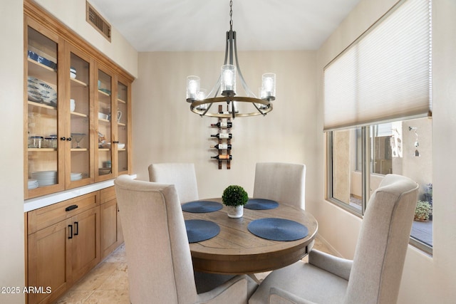 dining area featuring visible vents and an inviting chandelier