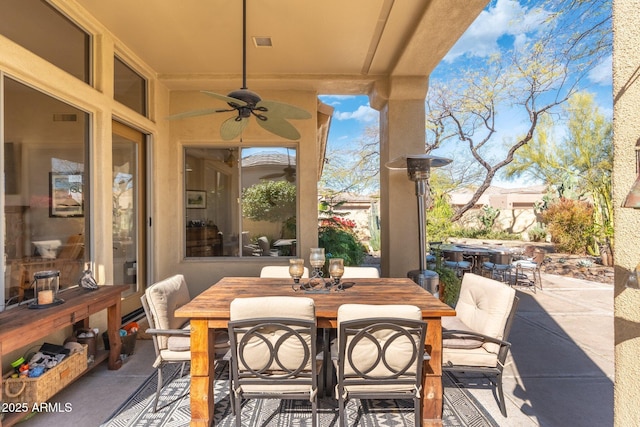view of patio / terrace with a ceiling fan, visible vents, and outdoor dining space