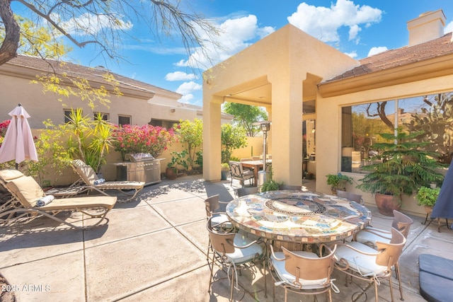 view of patio / terrace featuring a grill and outdoor dining space