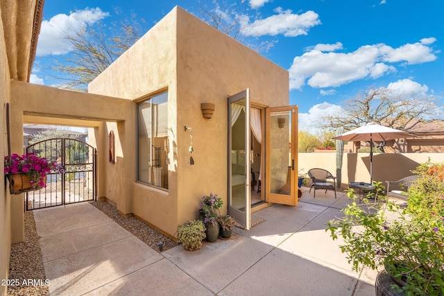 view of patio with a gate and fence