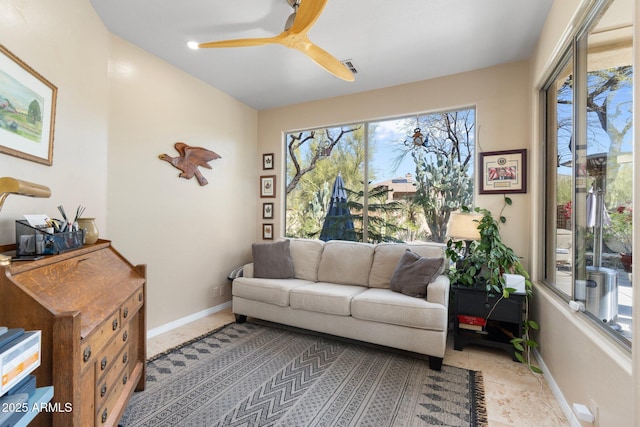 interior space featuring baseboards, visible vents, and ceiling fan