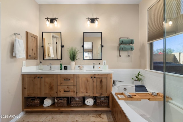 full bath featuring double vanity, a sink, and a garden tub