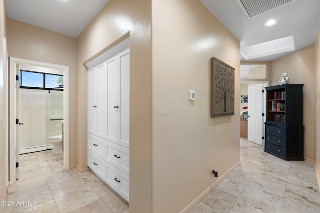 hall with baseboards, visible vents, a baseboard heating unit, and recessed lighting