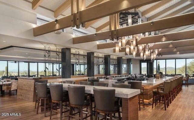 interior space featuring high vaulted ceiling, light wood-type flooring, and beam ceiling