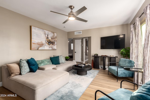 living room with ceiling fan and light hardwood / wood-style floors