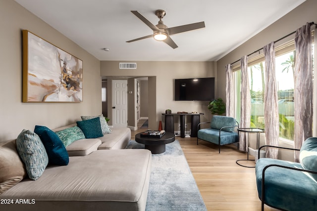 living room with ceiling fan and light wood-type flooring