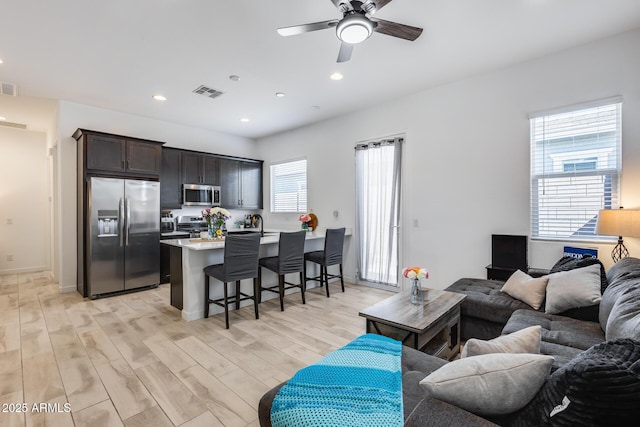 7694 W Desert Spoon Dr, Peoria, AZ 85383 - living room with ceiling fan, light wood-style flooring, recessed lighting, and baseboards