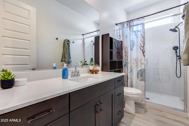 7694 W Desert Spoon Dr, Peoria, AZ 85383 - full bathroom with a shower stall, vanity, toilet, and wood finished floors
