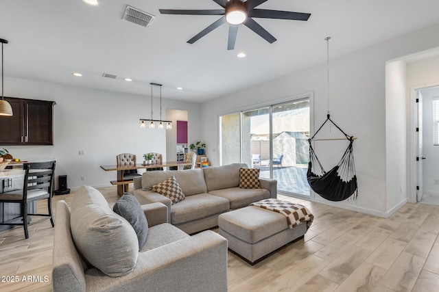 7694 W Desert Spoon Dr, Peoria, AZ 85383 - living room featuring light wood-type flooring, a ceiling fan, baseboards, recessed lighting, and a chandelier