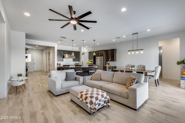7694 W Desert Spoon Dr, Peoria, AZ 85383 - living area with a ceiling fan, light wood-type flooring, recessed lighting, a chandelier, and baseboards