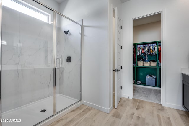 7694 W Desert Spoon Dr, Peoria, AZ 85383 - bathroom featuring a marble finish shower, wood finished floors, and vanity