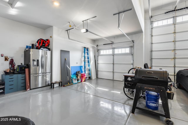 7694 W Desert Spoon Dr, Peoria, AZ 85383 - garage featuring stainless steel fridge with ice dispenser and a garage door opener