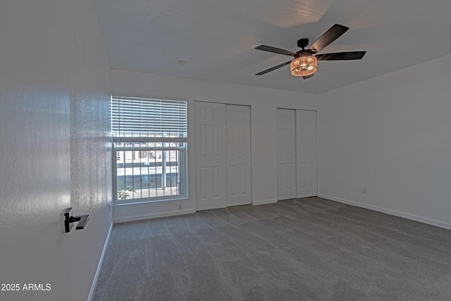 6044 W Augusta Ave, Glendale, AZ 85301 - unfurnished bedroom featuring two closets, carpet flooring, baseboards, and ceiling fan