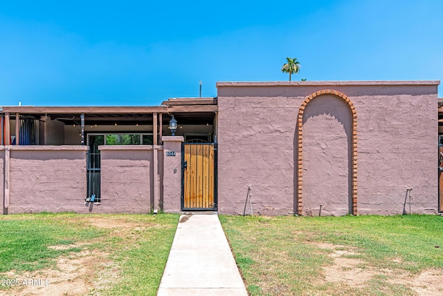 6044 W Augusta Ave, Glendale, AZ 85301 - view of front of home with a gate and stucco siding