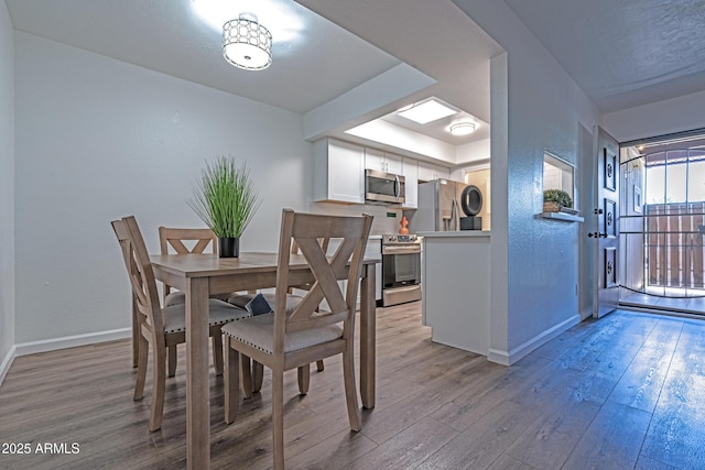 6044 W Augusta Ave, Glendale, AZ 85301 - dining area with light wood-style flooring and baseboards