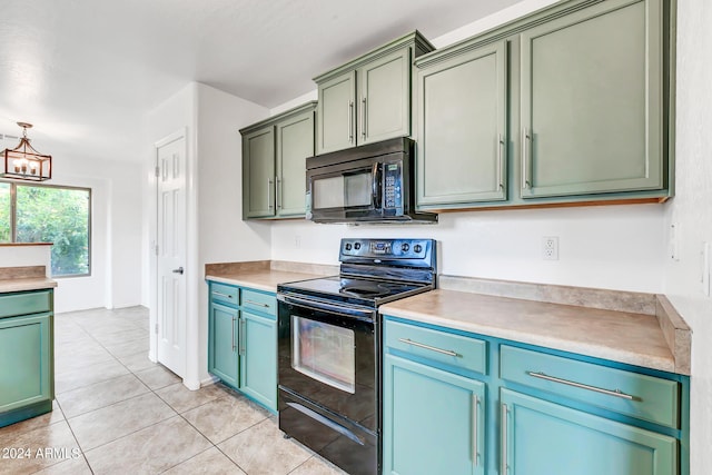 kitchen with light tile patterned floors, an inviting chandelier, green cabinets, and black appliances