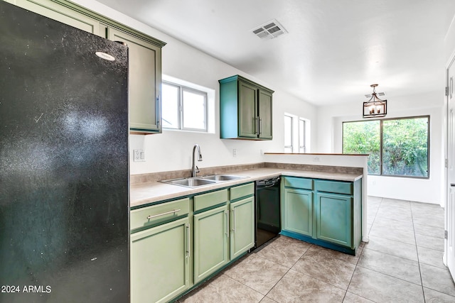 kitchen featuring pendant lighting, sink, black dishwasher, kitchen peninsula, and a chandelier