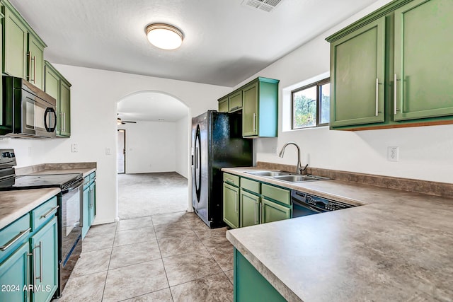 kitchen with ceiling fan, sink, green cabinets, light tile patterned floors, and black appliances